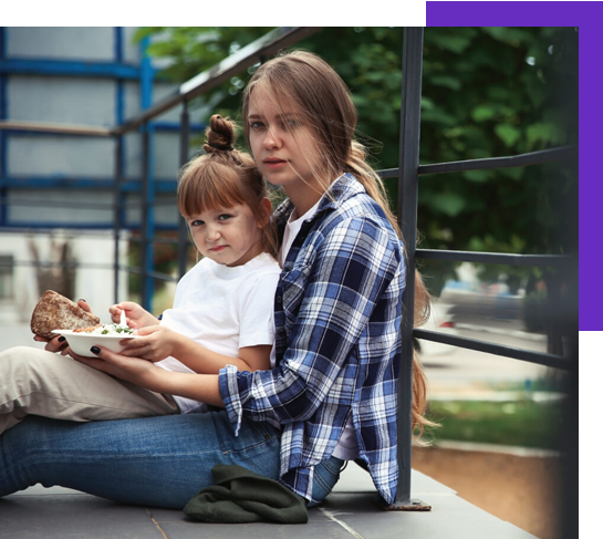 woman sitting down with a child sitting on her lap